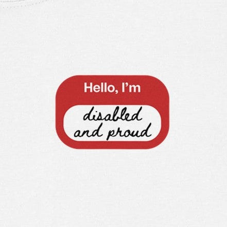 Close-up of a red and white print that looks like a name sticker. It reads Hello, I'm disabled and proud.