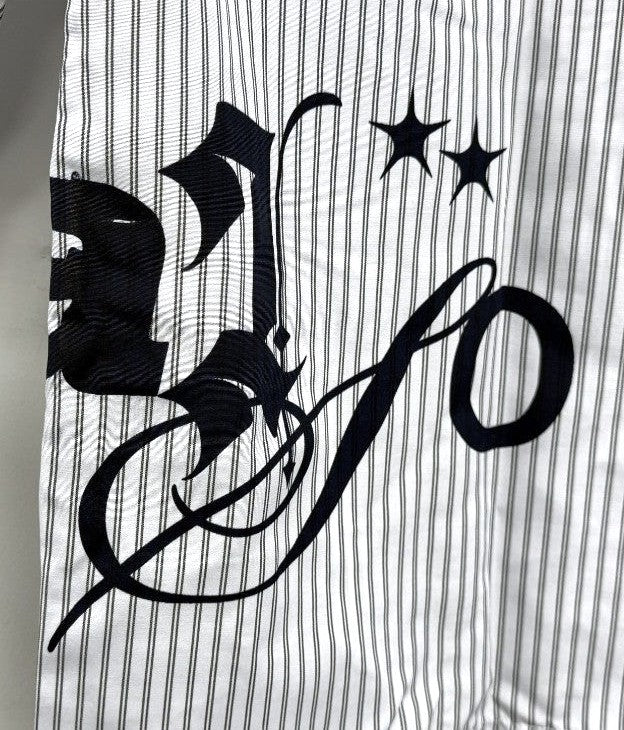 Black decorative letter 'S' on a white background with black stars